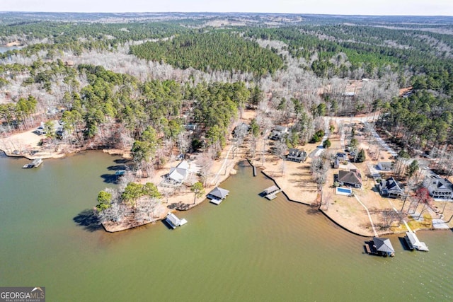 aerial view with a water view and a forest view