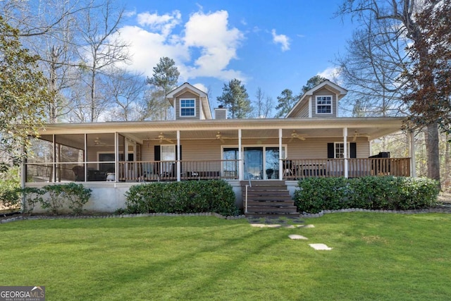 farmhouse-style home featuring a front lawn, a sunroom, stairway, and a ceiling fan