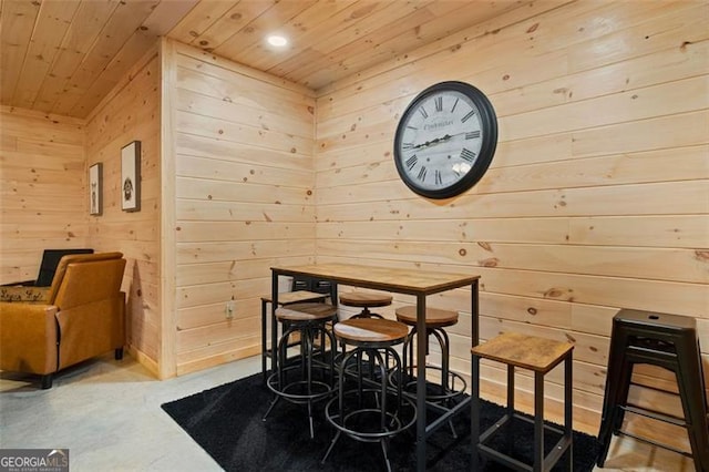 dining space featuring recessed lighting, wooden walls, and wooden ceiling