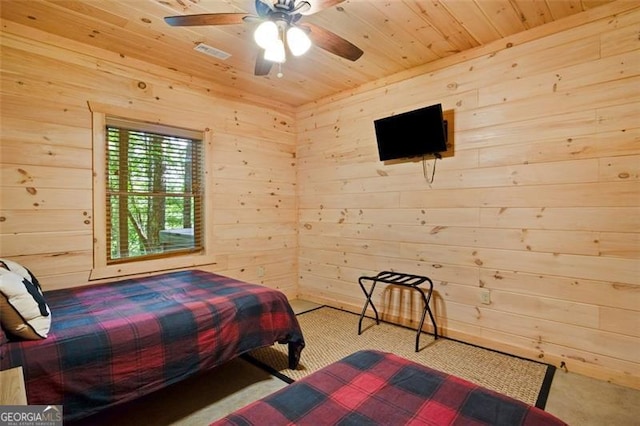 carpeted bedroom featuring wood walls, visible vents, wood ceiling, and a ceiling fan