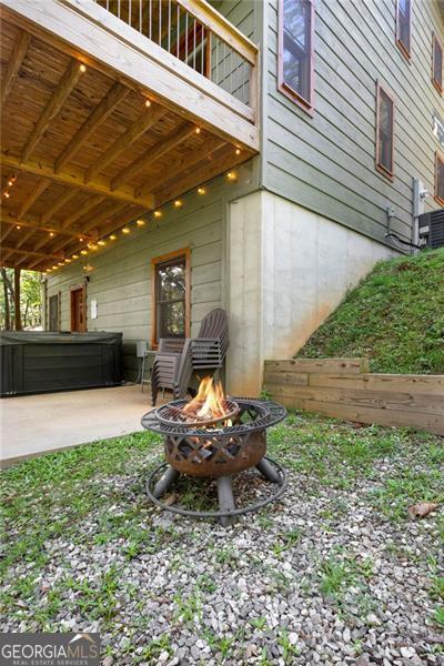 view of yard with cooling unit, a patio area, and a fire pit