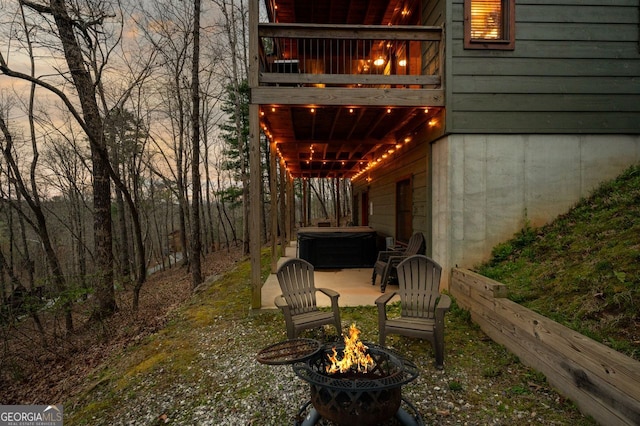 view of patio featuring a fire pit and a hot tub