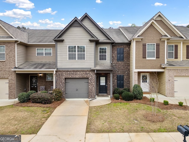 249 Madison Ave, Acworth, GA 30102 - view of property featuring concrete driveway, an attached garage, brick siding, and a shingled roof