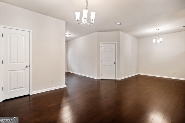 249 Madison Ave, Acworth, GA 30102 - spare room with baseboards, a notable chandelier, and dark wood-style flooring