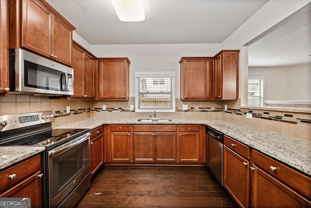 249 Madison Ave, Acworth, GA 30102 - kitchen with dark wood-type flooring, light stone countertops, appliances with stainless steel finishes, and a sink