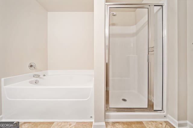 249 Madison Ave, Acworth, GA 30102 - bathroom featuring a shower stall, a garden tub, and baseboards