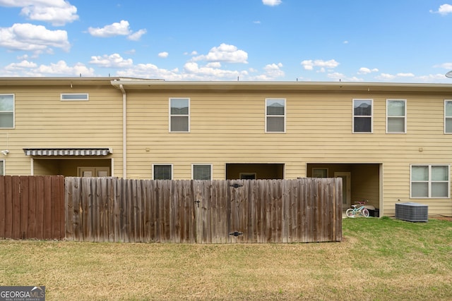 249 Madison Ave, Acworth, GA 30102 - rear view of house with fence, a lawn, and central AC