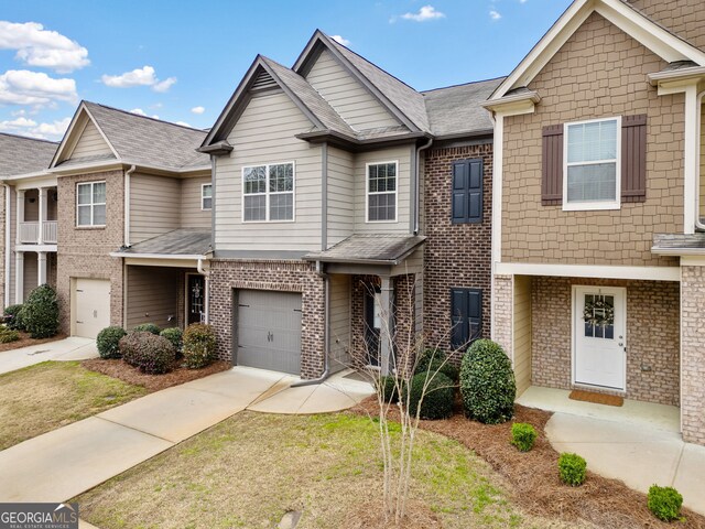 249 Madison Ave, Acworth, GA 30102 - townhome / multi-family property with brick siding, an attached garage, concrete driveway, and roof with shingles