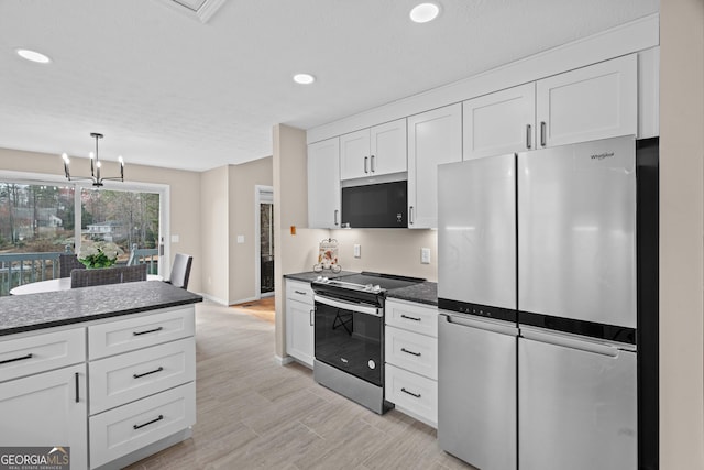 1190 Plantation Dr, Villa Rica, GA 30180 - kitchen with white cabinetry, decorative light fixtures, recessed lighting, and appliances with stainless steel finishes