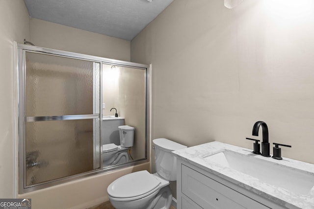 1190 Plantation Dr, Villa Rica, GA 30180 - bathroom with a textured ceiling, toilet, vanity, and shower / bath combination with glass door