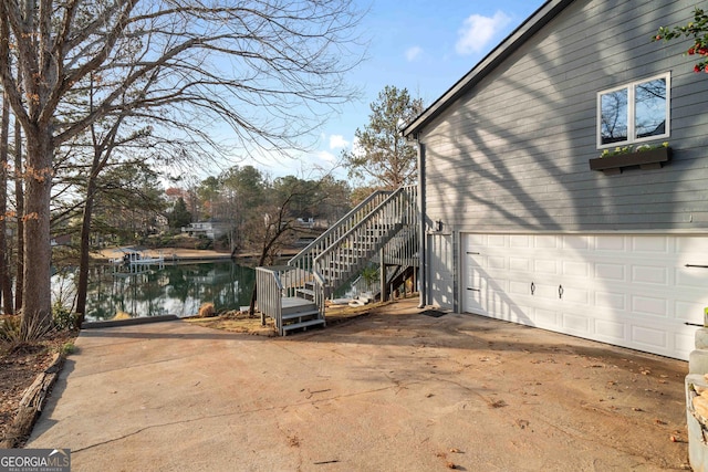 1190 Plantation Dr, Villa Rica, GA 30180 - view of side of home featuring concrete driveway, stairway, and an attached garage