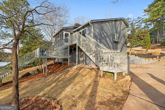 1190 Plantation Dr, Villa Rica, GA 30180 - exterior space with a wooden deck, stairs, and a sunroom