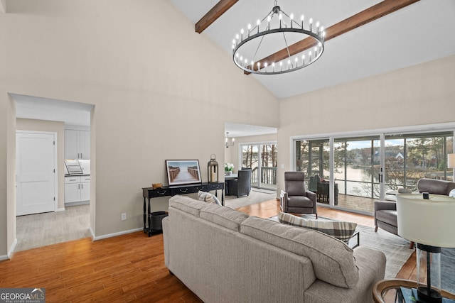1190 Plantation Dr, Villa Rica, GA 30180 - living area with baseboards, light wood-type flooring, beam ceiling, a notable chandelier, and high vaulted ceiling