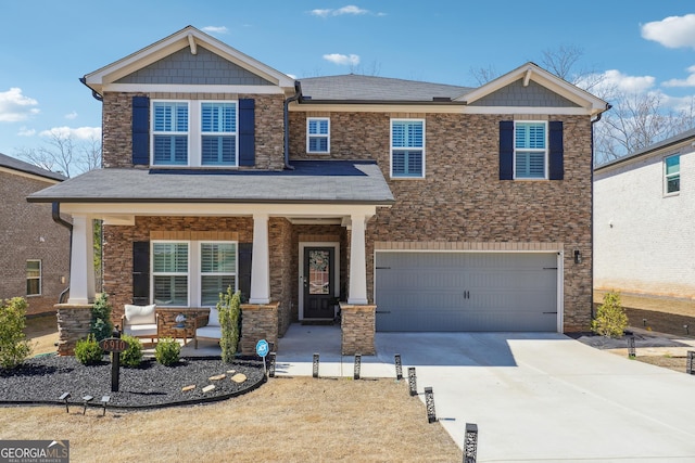 craftsman inspired home featuring stone siding, a porch, concrete driveway, and an attached garage