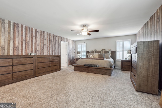 bedroom featuring light carpet, multiple windows, and a ceiling fan