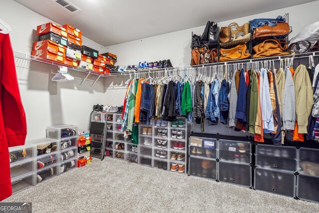 spacious closet featuring visible vents and carpet floors