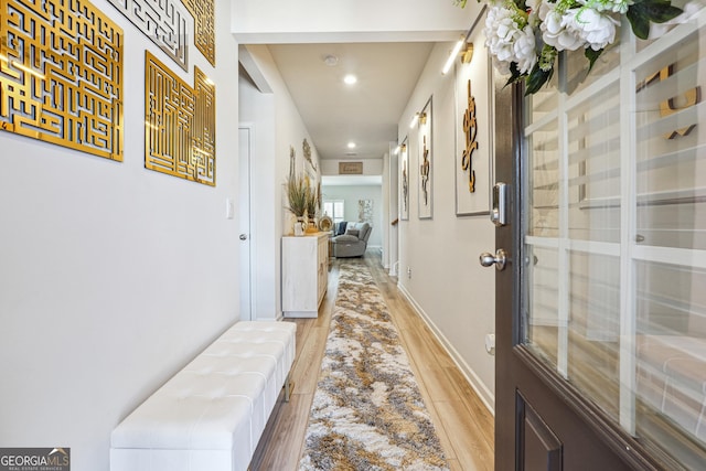 hall with recessed lighting, baseboards, and light wood-style floors