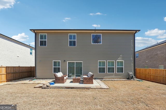 back of property with a fenced backyard, a lawn, outdoor lounge area, and a patio