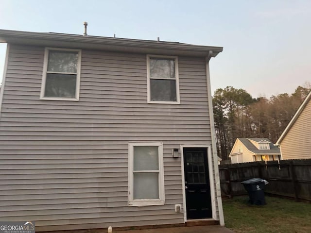 rear view of property with fence