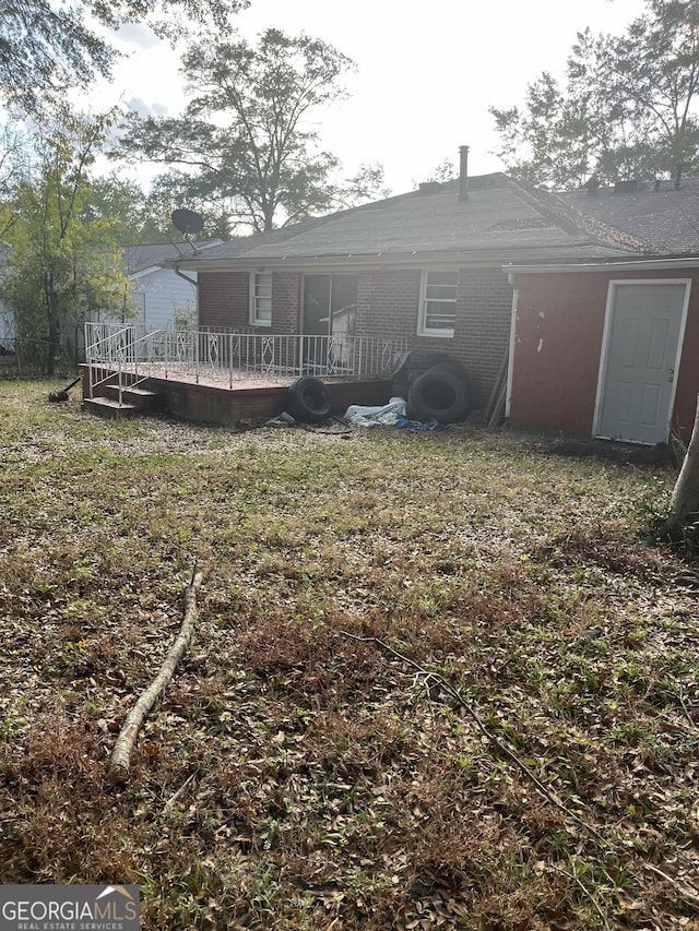 back of property featuring a wooden deck
