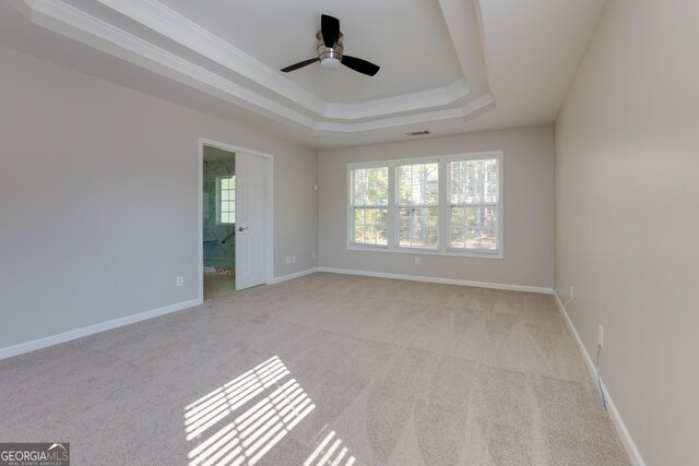 unfurnished room featuring ceiling fan, baseboards, crown molding, and a tray ceiling