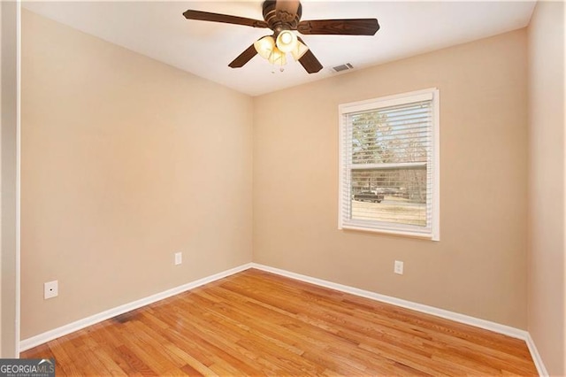 spare room with visible vents, baseboards, light wood-style floors, and a ceiling fan