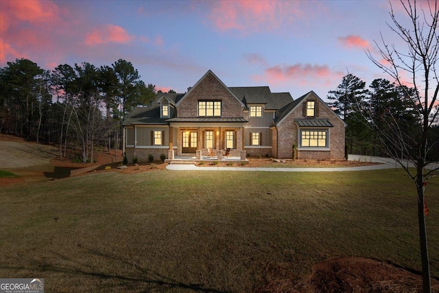 104 Piedmont Cir, Forsyth, GA 31029 - view of front of home featuring covered porch, a standing seam roof, a yard, and metal roof