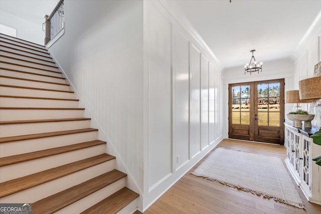 104 Piedmont Cir, Forsyth, GA 31029 - entrance foyer with stairway, a chandelier, french doors, and wood finished floors