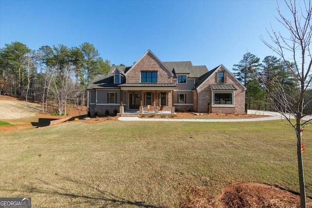 104 Piedmont Cir, Forsyth, GA 31029 - craftsman inspired home featuring covered porch, a standing seam roof, a front yard, and metal roof