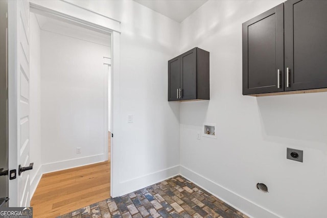 104 Piedmont Cir, Forsyth, GA 31029 - laundry area featuring electric dryer hookup, cabinet space, washer hookup, baseboards, and wood finished floors
