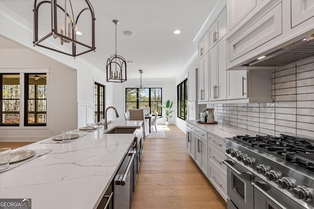 104 Piedmont Cir, Forsyth, GA 31029 - kitchen with double oven range, a sink, light stone counters, decorative backsplash, and recessed lighting