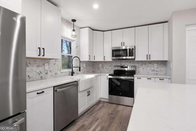 2014 Poplar Rdg, Lawrenceville, GA 30044 - kitchen featuring dark wood finished floors, white cabinets, appliances with stainless steel finishes, a sink, and decorative backsplash