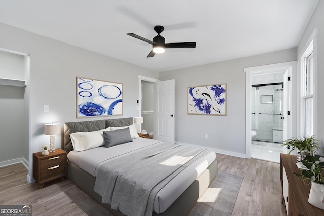 2014 Poplar Rdg, Lawrenceville, GA 30044 - bedroom featuring light wood-style floors, baseboards, connected bathroom, and ceiling fan