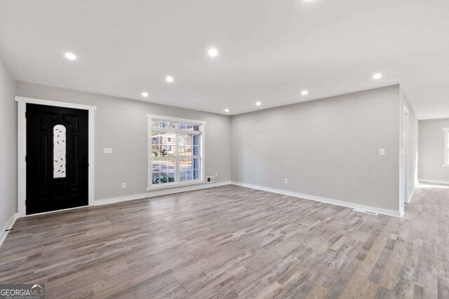 2014 Poplar Rdg, Lawrenceville, GA 30044 - unfurnished living room featuring wood finished floors, baseboards, visible vents, and recessed lighting
