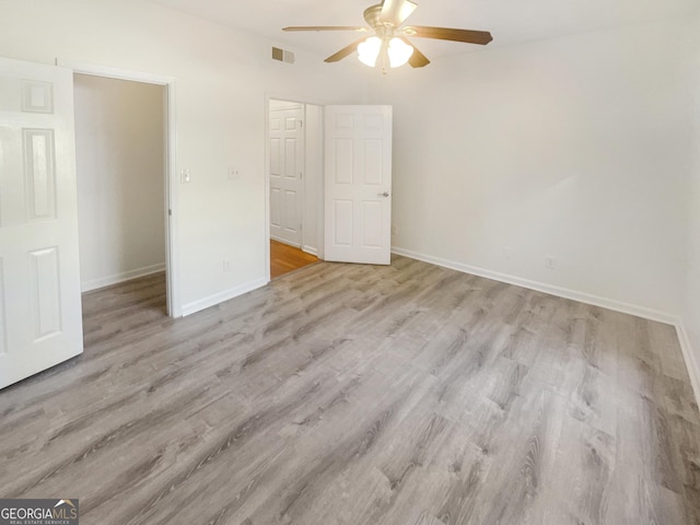 1250 Parkwood Cir SE Unit 300/230, Atlanta, GA 30339 - unfurnished bedroom with wood finished floors, baseboards, and a ceiling fan