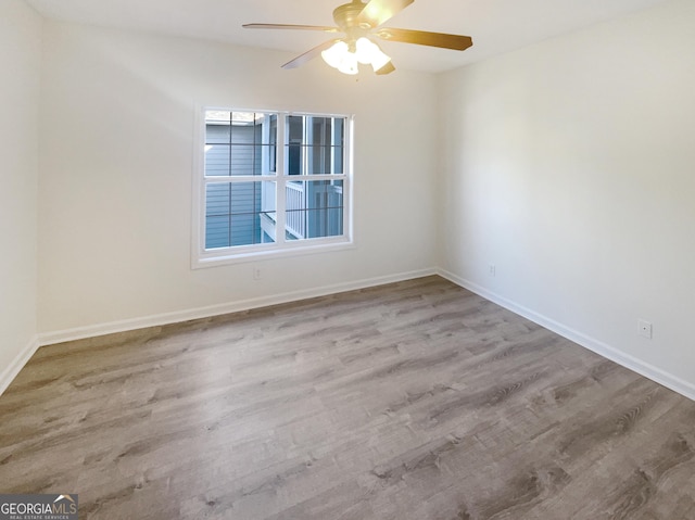 1250 Parkwood Cir SE Unit 300/230, Atlanta, GA 30339 - spare room featuring wood finished floors, ceiling fan, and baseboards