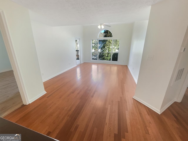 1250 Parkwood Cir SE Unit 300/230, Atlanta, GA 30339 - unfurnished living room with light wood finished floors, ceiling fan, and baseboards