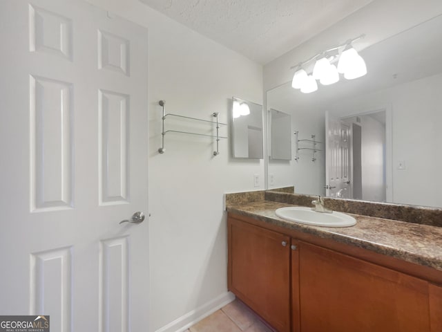 1250 Parkwood Cir SE Unit 300/230, Atlanta, GA 30339 - bathroom with tile patterned flooring, vanity, a textured ceiling, and baseboards