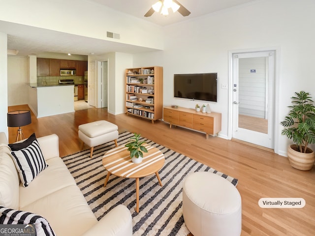 1250 Parkwood Cir SE Unit 300/230, Atlanta, GA 30339 - living area featuring light wood-type flooring, a ceiling fan, and baseboards