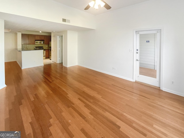 1250 Parkwood Cir SE Unit 300/230, Atlanta, GA 30339 - unfurnished living room with ceiling fan, light wood-style floors, baseboards, and ornamental molding