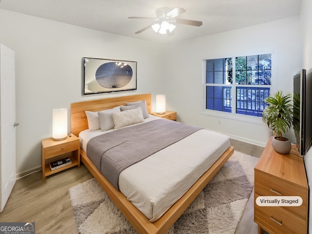 1250 Parkwood Cir SE Unit 300/230, Atlanta, GA 30339 - bedroom featuring wood finished floors, baseboards, and a ceiling fan