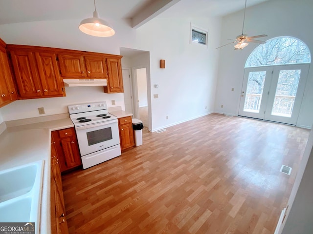 3515 S Bend Rd, Gainesville, GA 30506 - kitchen featuring white range with electric stovetop, under cabinet range hood, high vaulted ceiling, light countertops, and light wood finished floors