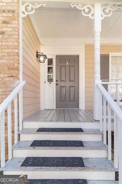 view of exterior entry with covered porch