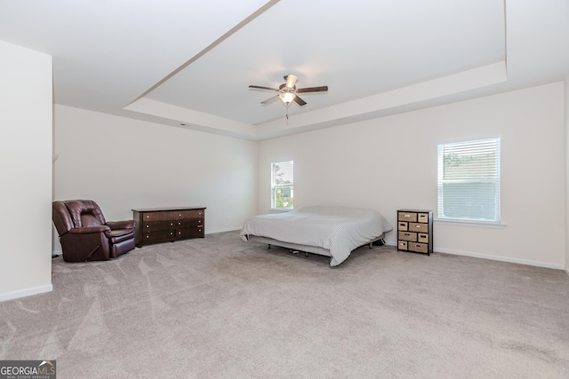 3391 Meadow Grass Dr, Dacula, GA 30019 - carpeted bedroom featuring a tray ceiling, baseboards, and a ceiling fan
