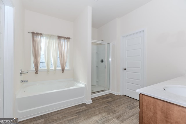 3391 Meadow Grass Dr, Dacula, GA 30019 - bathroom with wood finished floors, a stall shower, a bath, and vanity