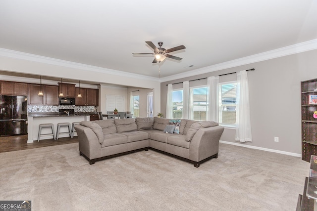 3391 Meadow Grass Dr, Dacula, GA 30019 - living room with ornamental molding, ceiling fan, baseboards, and light colored carpet