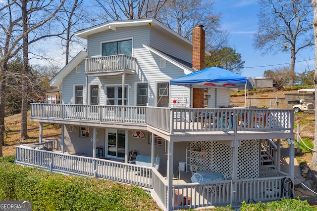 1696 Crawfords Ferry Rd, Hartwell, GA 30643 - back of house with a patio, stairway, a wooden deck, and a chimney