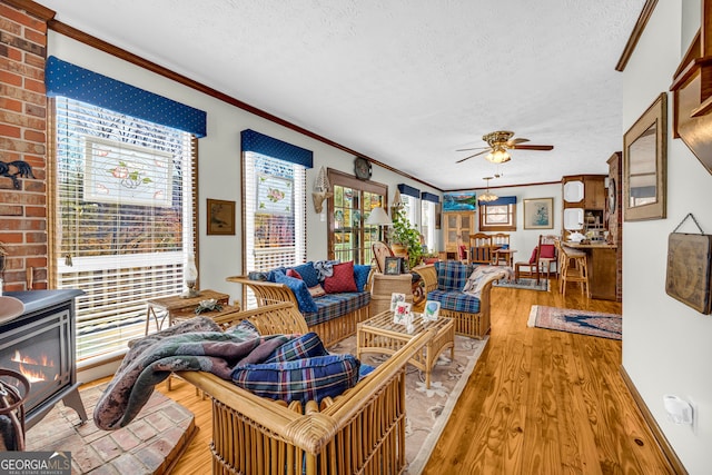 1696 Crawfords Ferry Rd, Hartwell, GA 30643 - living area with a textured ceiling, crown molding, ceiling fan, and wood finished floors