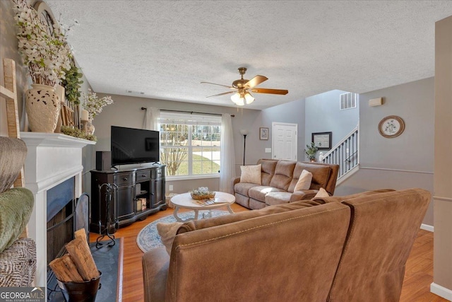 81 Summer Creek Dr, Dallas, GA 30157 - living area featuring visible vents, a fireplace, light wood-type flooring, and ceiling fan
