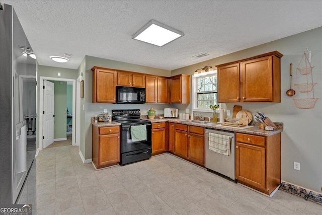 81 Summer Creek Dr, Dallas, GA 30157 - kitchen with black appliances, visible vents, and brown cabinets